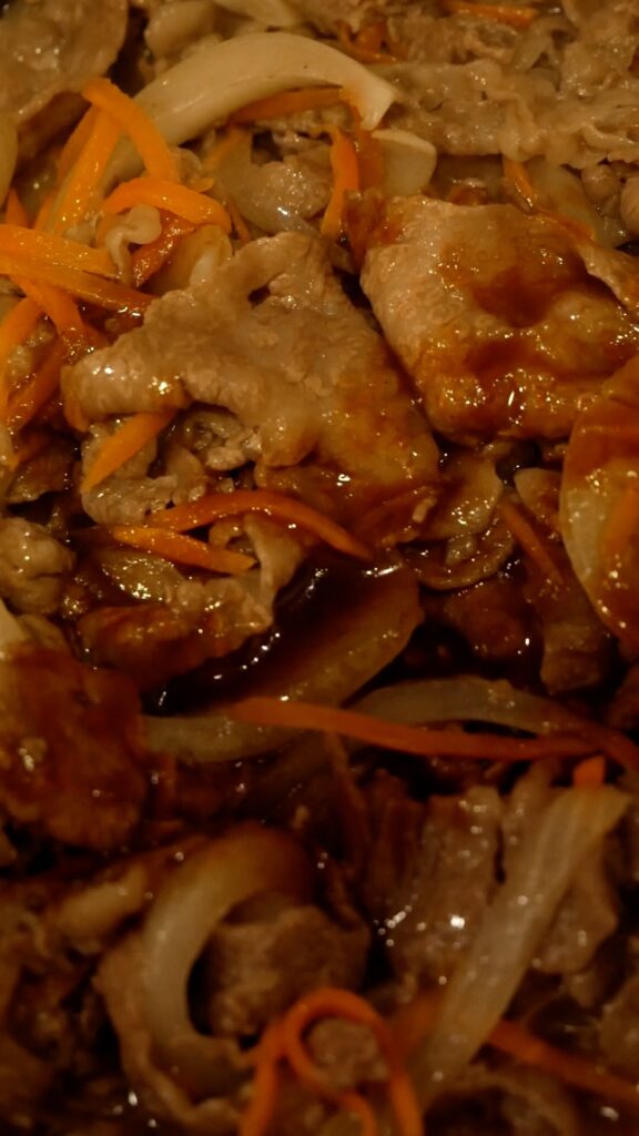 焼肉のタレで味付け中の牛肉と玉ねぎ、にんじん