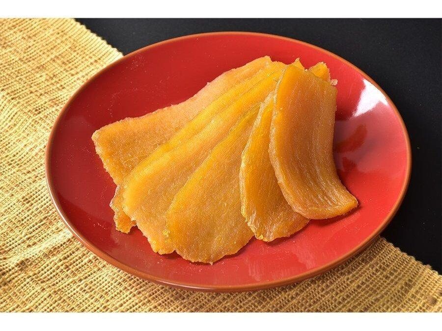 Slices of dried sweet potatoes on a red plate