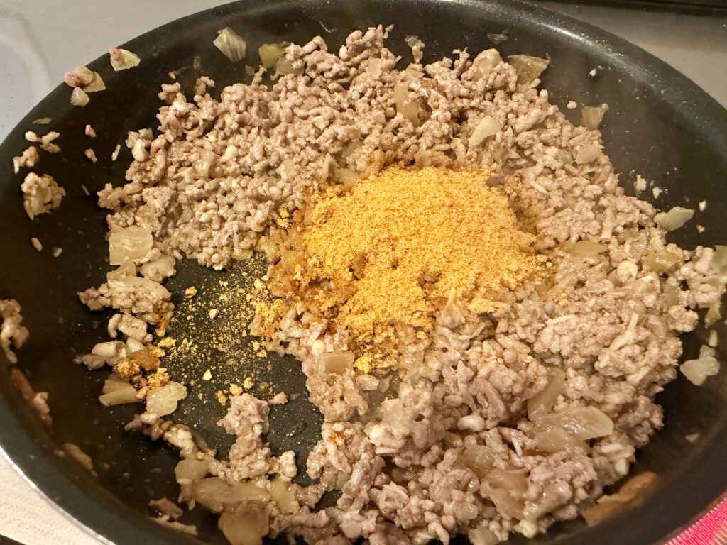 タコライスの具材となる合い挽き肉と玉ねぎを炒め、タコライスの素を加える前の様子